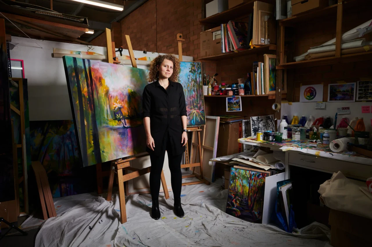 Olga among paintings in her studio